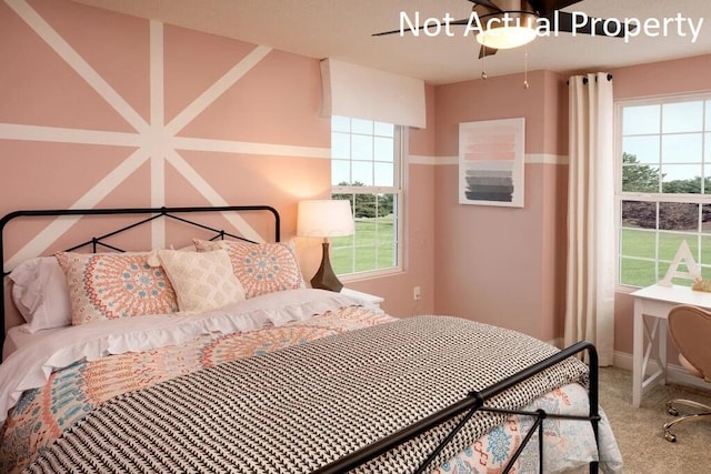 bedroom featuring baseboards, multiple windows, and carpet flooring