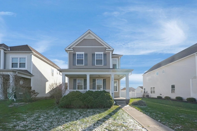 view of front of property featuring a front lawn and covered porch