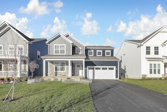 front facade featuring a front lawn, a porch, and a garage