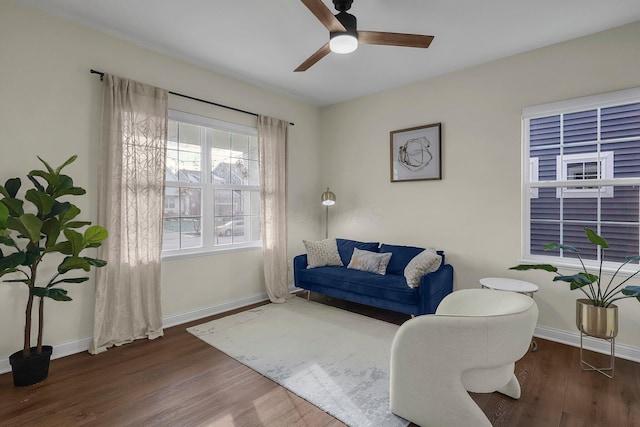 living room with ceiling fan and dark hardwood / wood-style flooring