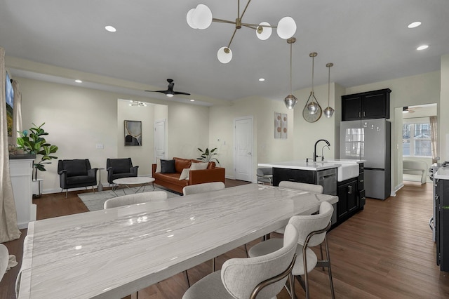 dining area featuring ceiling fan and dark wood-type flooring