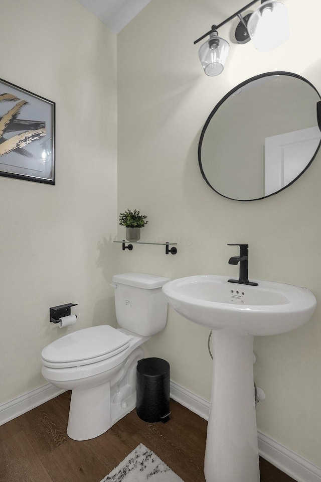 bathroom featuring toilet and wood-type flooring