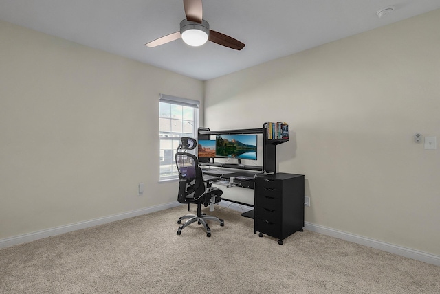 carpeted home office featuring ceiling fan