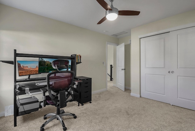 carpeted office space featuring ceiling fan