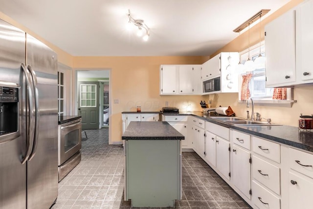 kitchen featuring black microwave, white cabinets, stainless steel fridge with ice dispenser, a kitchen island, and range