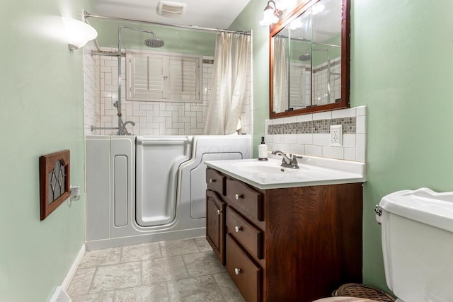 full bathroom with vanity, toilet, backsplash, and shower / washtub combination