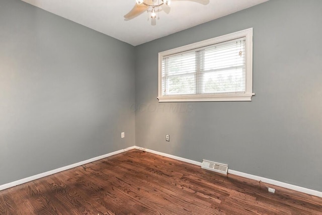 empty room with dark hardwood / wood-style floors and ceiling fan