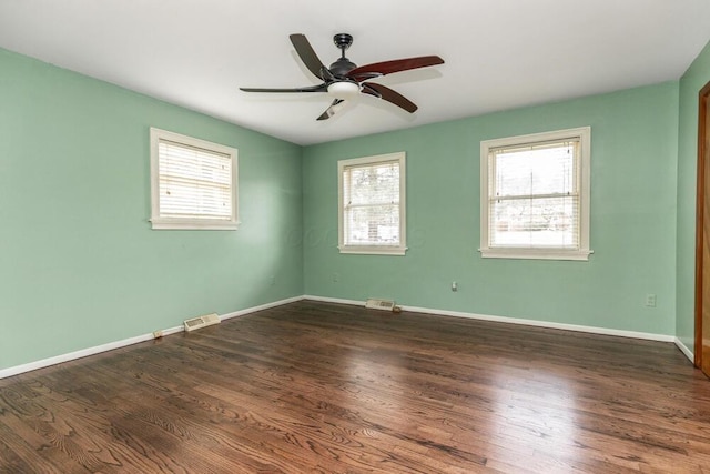 unfurnished room featuring ceiling fan and dark wood-type flooring