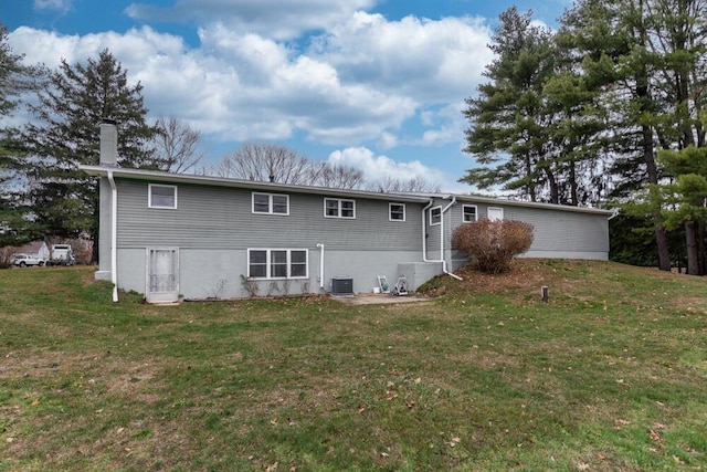 rear view of property with a yard