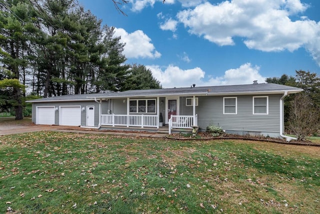 ranch-style house with covered porch, a garage, and a front lawn