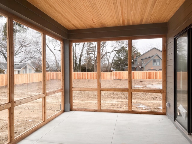 unfurnished sunroom with wooden ceiling