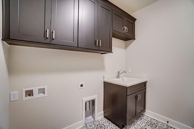 laundry room featuring hookup for an electric dryer, washer hookup, a sink, baseboards, and cabinet space