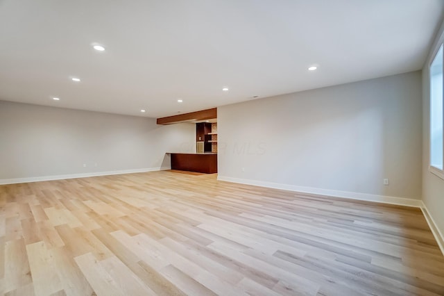 spare room featuring baseboards, light wood finished floors, and recessed lighting