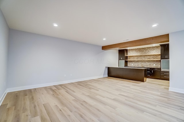 unfurnished office featuring light wood-style flooring, baseboards, and recessed lighting