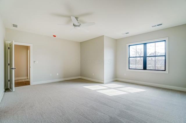 empty room with light carpet, baseboards, and visible vents