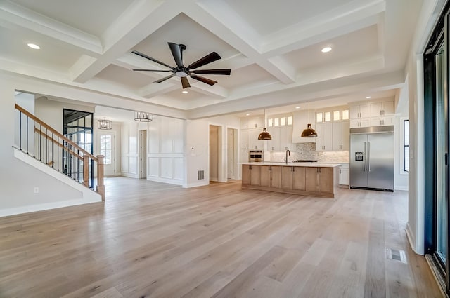 kitchen featuring visible vents, appliances with stainless steel finishes, open floor plan, and light countertops