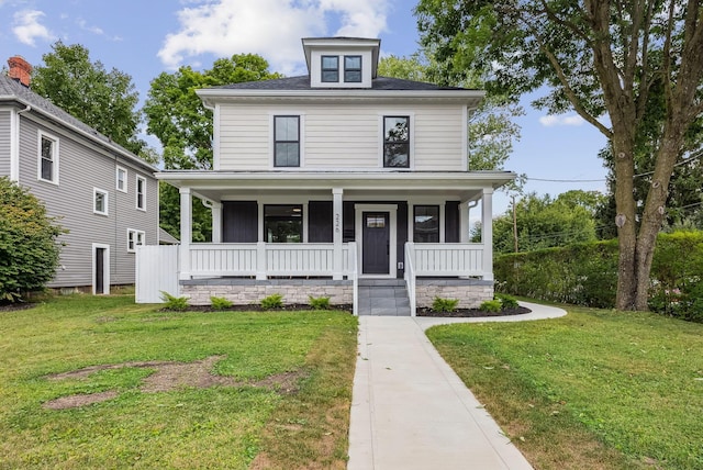 view of front of property with covered porch and a front lawn