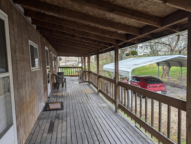 wooden deck featuring a carport