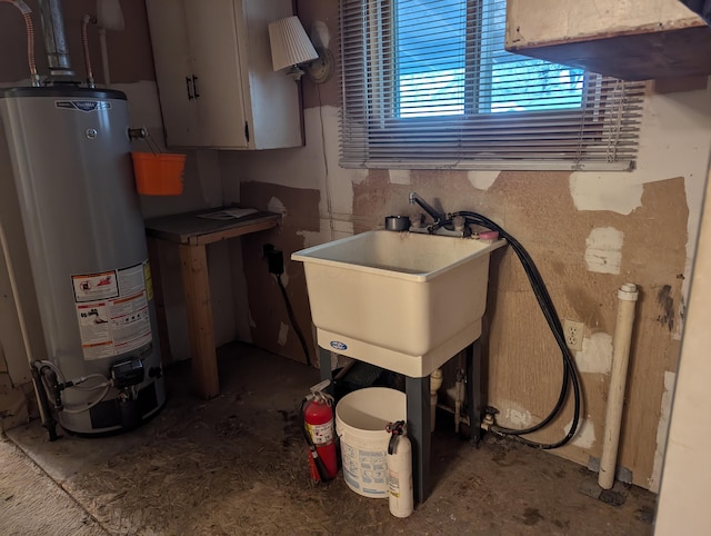 utility room with sink and gas water heater