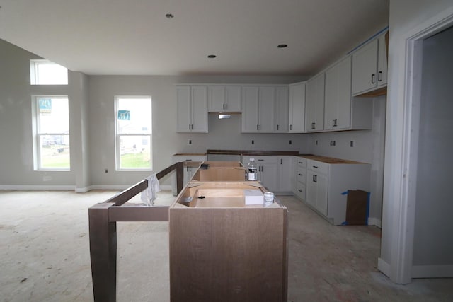 kitchen featuring sink, white cabinets, and a center island