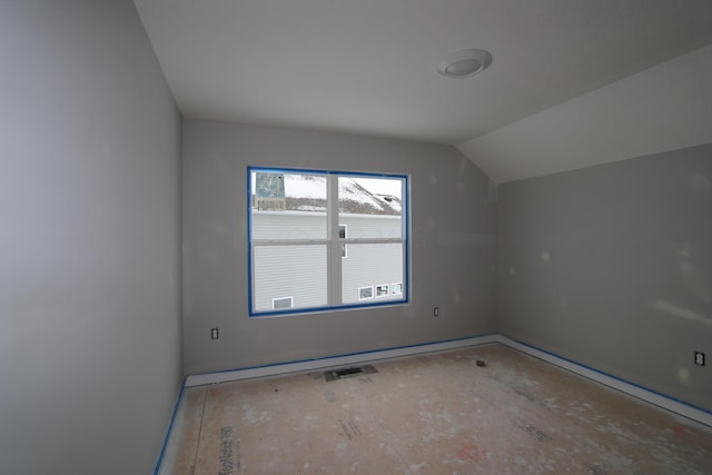 additional living space featuring lofted ceiling