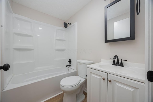 full bathroom featuring hardwood / wood-style floors,  shower combination, a textured ceiling, toilet, and vanity