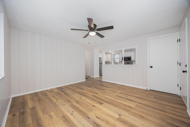 empty room featuring wood-type flooring, a textured ceiling, and ceiling fan