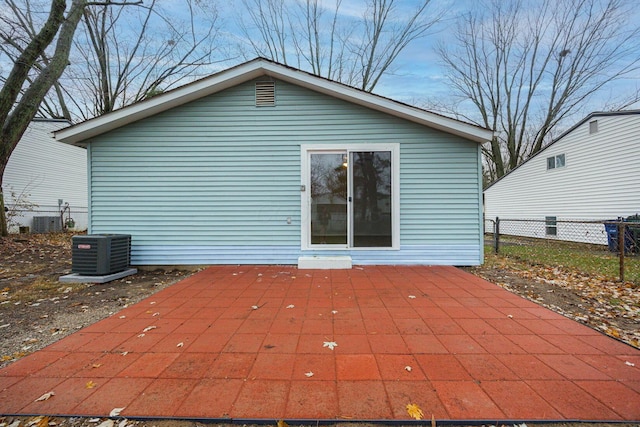 back of property with central AC and a patio area