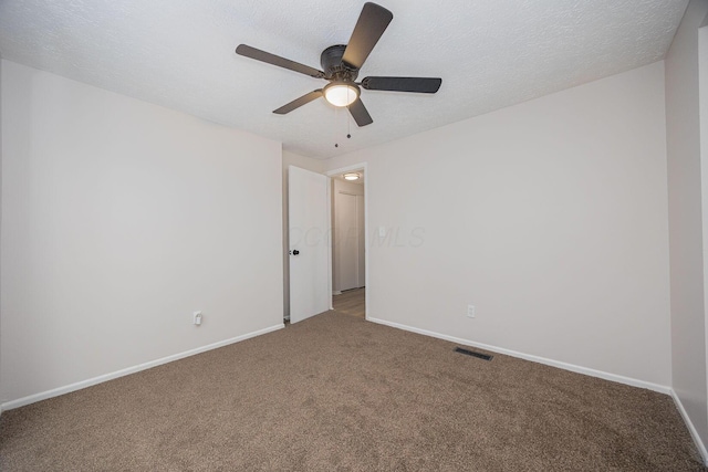 carpeted empty room with a textured ceiling and ceiling fan