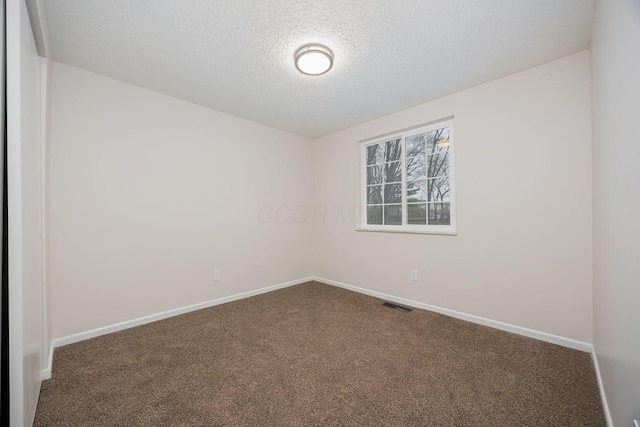 carpeted spare room with a textured ceiling