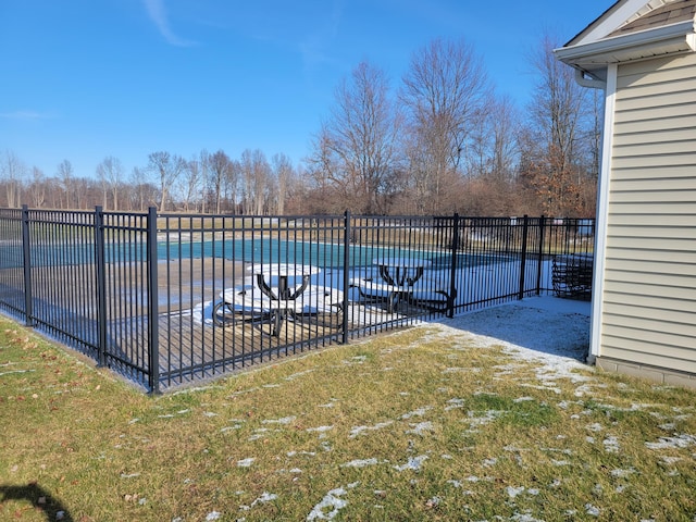 view of pool featuring a lawn