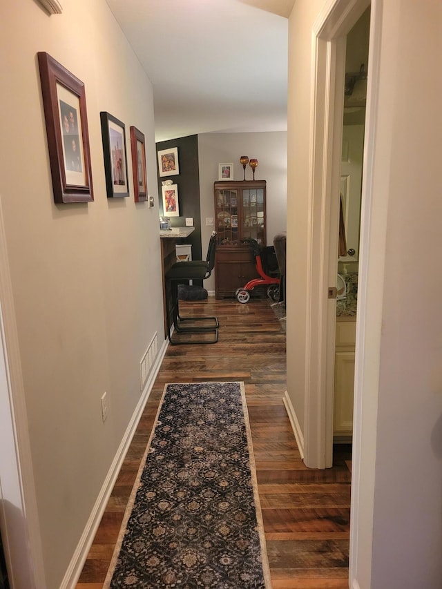 hallway featuring dark wood-type flooring