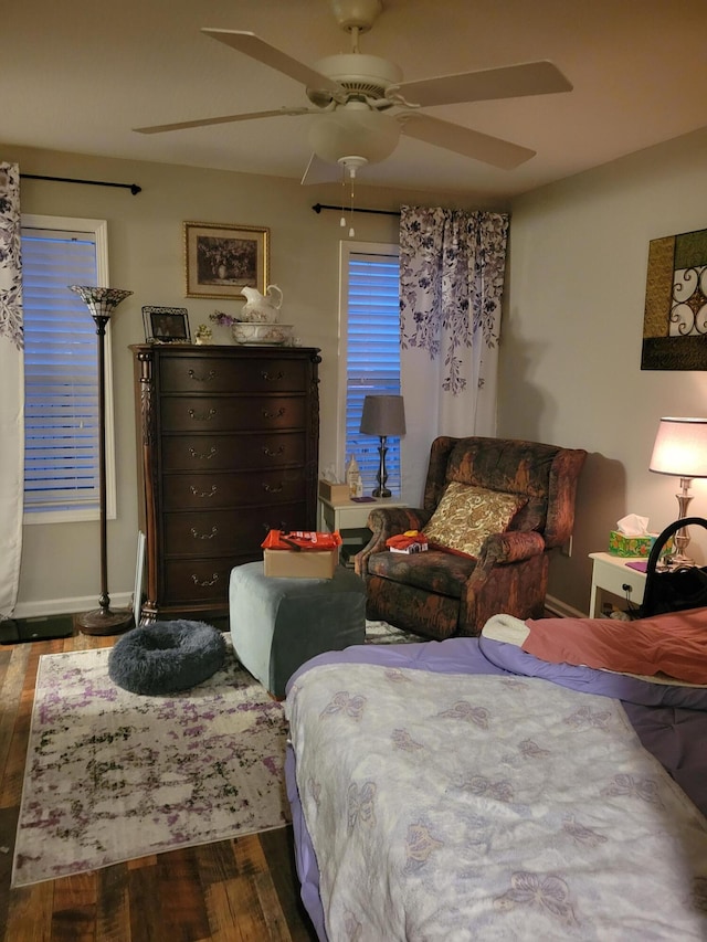 bedroom with ceiling fan and dark hardwood / wood-style flooring