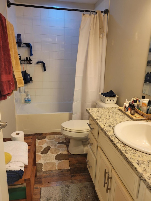 full bathroom with hardwood / wood-style flooring, shower / bath combination with curtain, toilet, and vanity