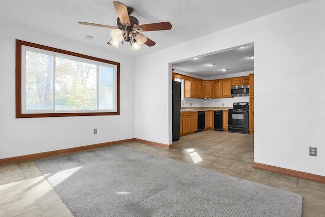 kitchen featuring ceiling fan, black appliances, and a textured ceiling