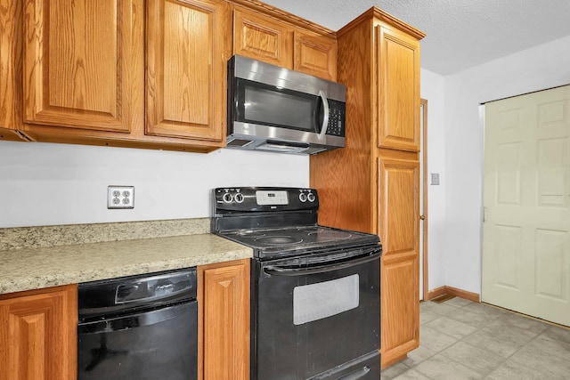 kitchen featuring light stone countertops, black electric range oven, and a textured ceiling