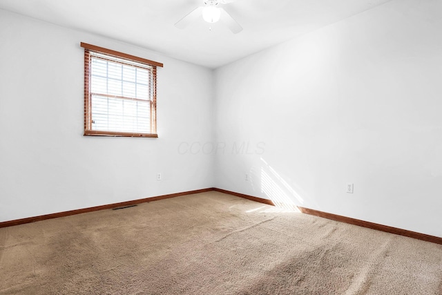 carpeted empty room featuring ceiling fan