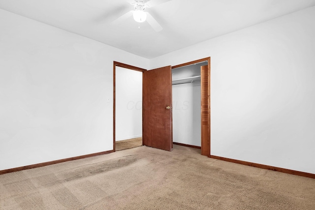 unfurnished bedroom featuring carpet, a closet, and ceiling fan