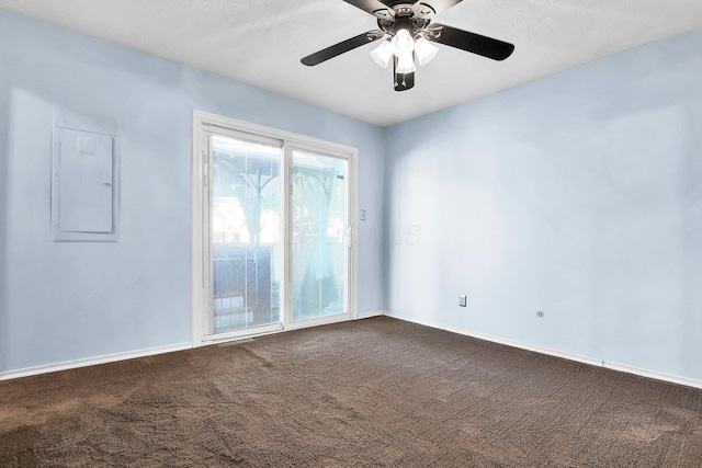 carpeted empty room with a textured ceiling, electric panel, and ceiling fan