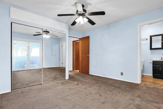 unfurnished bedroom with carpet flooring, connected bathroom, a closet, and ceiling fan