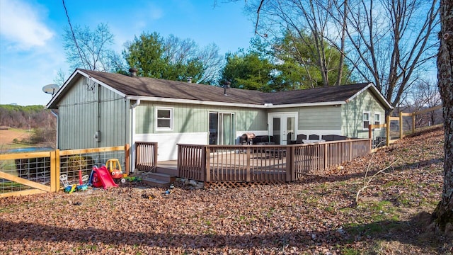 back of property with french doors and a wooden deck