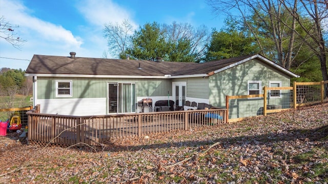 rear view of house featuring a deck and french doors