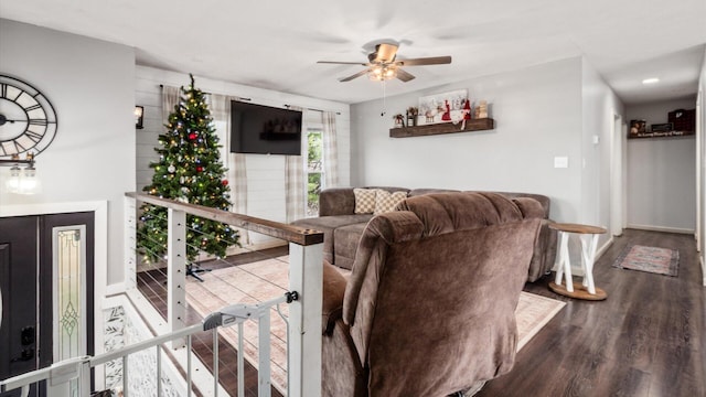 living room with wood-type flooring and ceiling fan