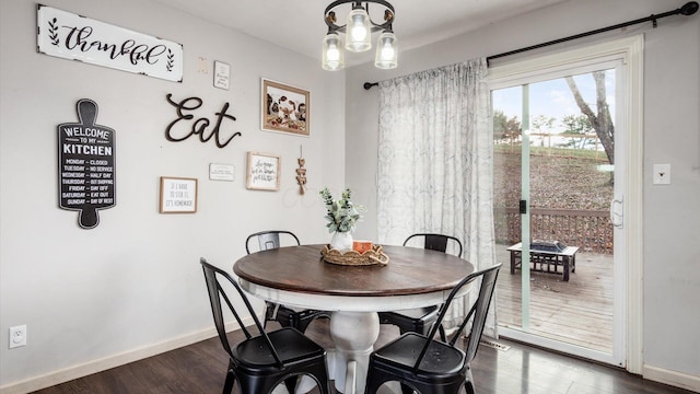 dining space with dark hardwood / wood-style flooring