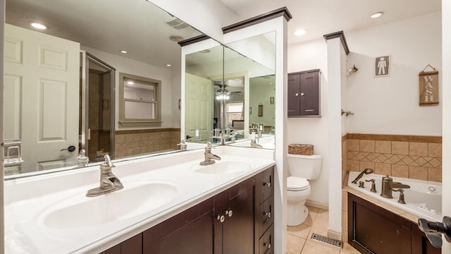 bathroom featuring ceiling fan, tile patterned floors, a tub to relax in, toilet, and vanity