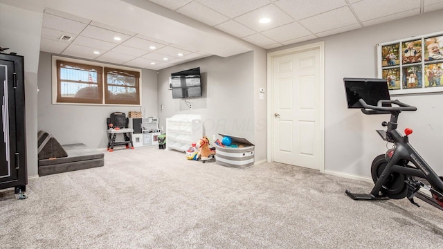 recreation room featuring carpet and a drop ceiling