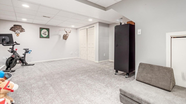 rec room featuring carpet floors and a drop ceiling