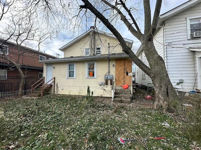 rear view of house featuring cooling unit