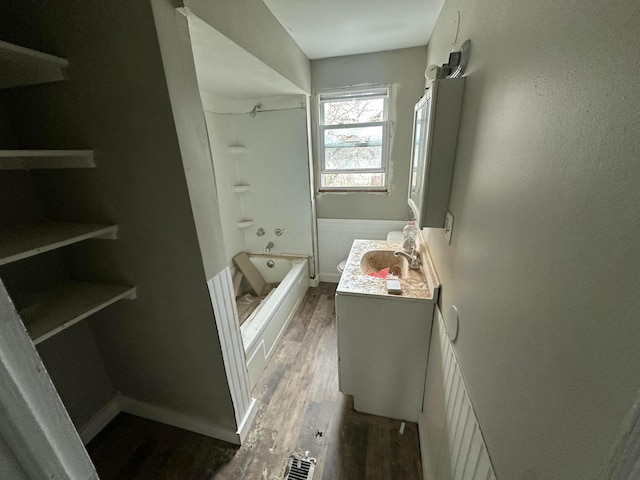 bathroom with shower / tub combination, vanity, and hardwood / wood-style flooring