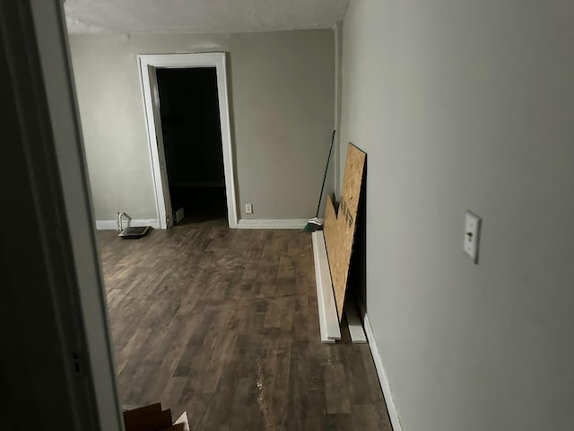 hallway with dark hardwood / wood-style floors